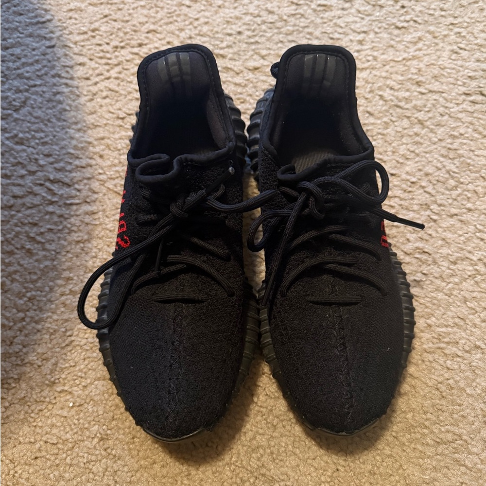 Yeezy Black Athletic Shoes with Red Accents